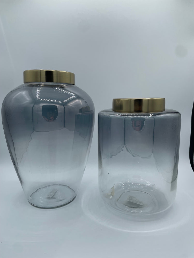 Two Smoky ombre glass vases with gold caps on a white background