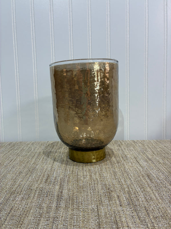 Beige Colored cylindrical Vase on a textured surface with a white background