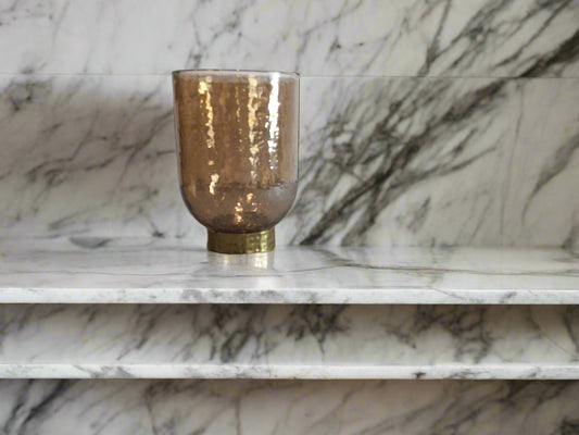 glass vase with a beige color with a gold base
